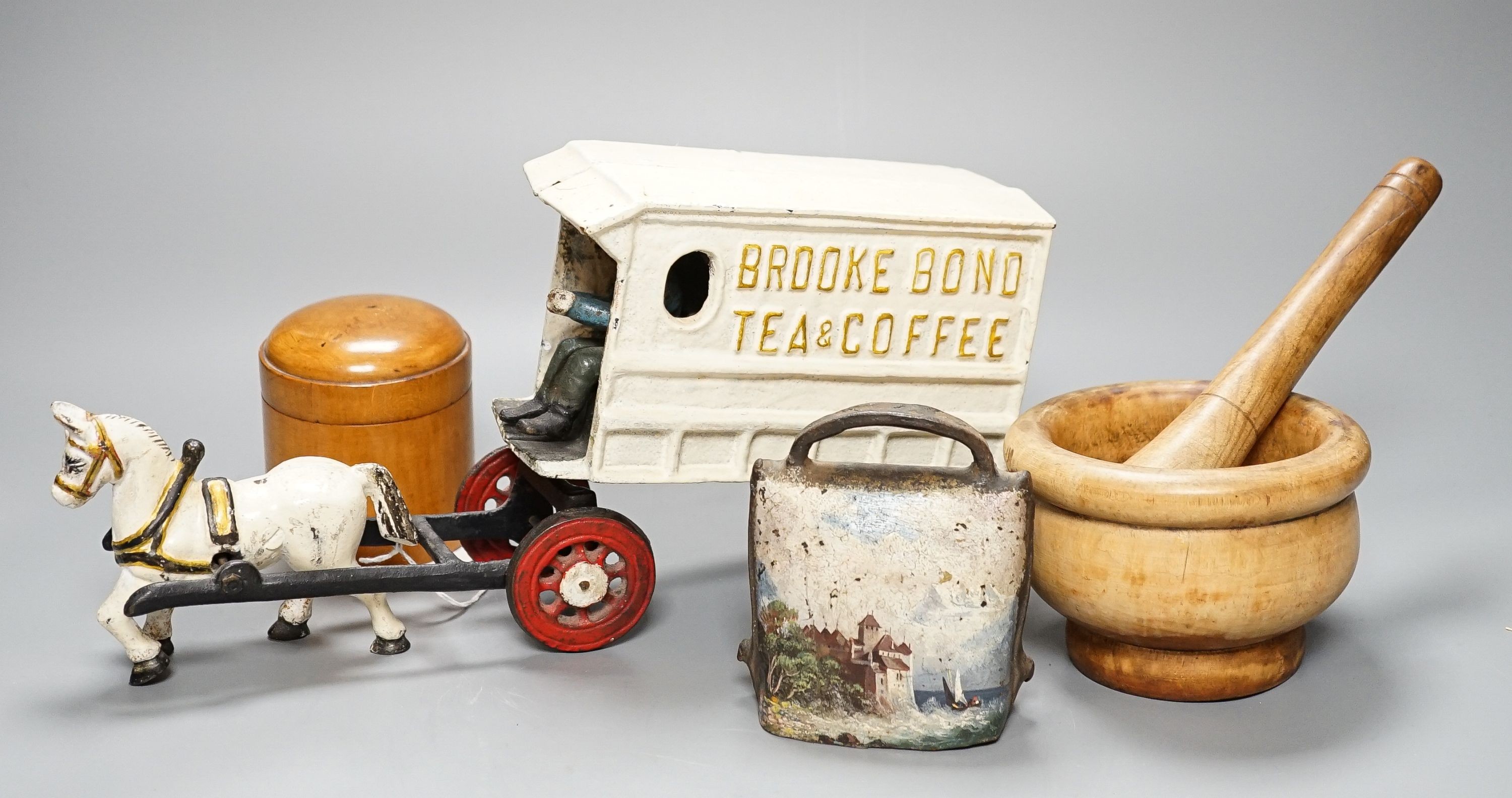 A miscellaneous collection comprising a painted cast iron Brooke Bond pony and cart, train items to include a mortar and pestle, a European painted cowbell, lacquer wares et cetera